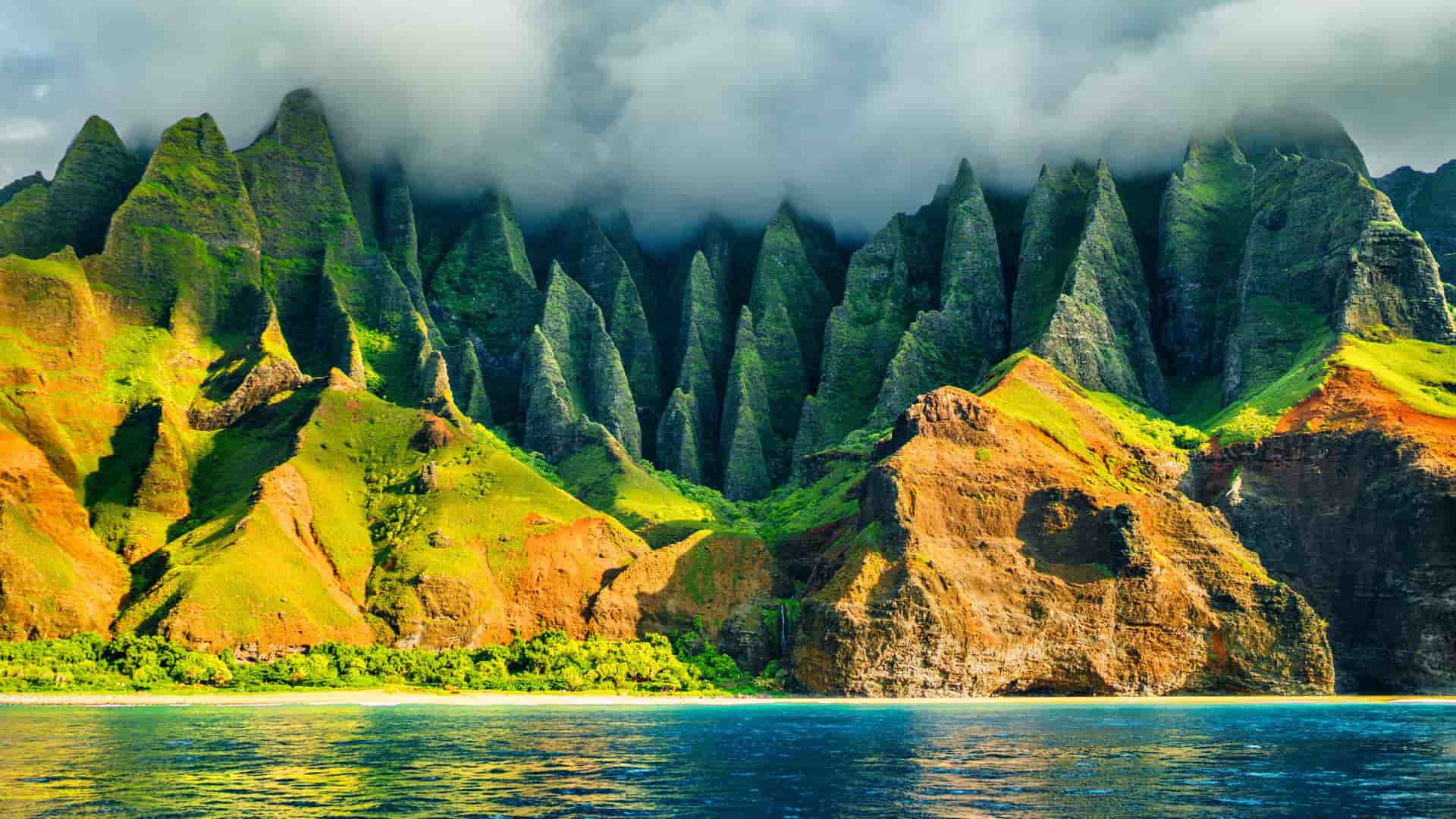 Azamara Cruises: Na Pali Coast, Kauai, Hawaii - dramatic emerald cliffs, valleys, beach, turquoise Pacific waters.