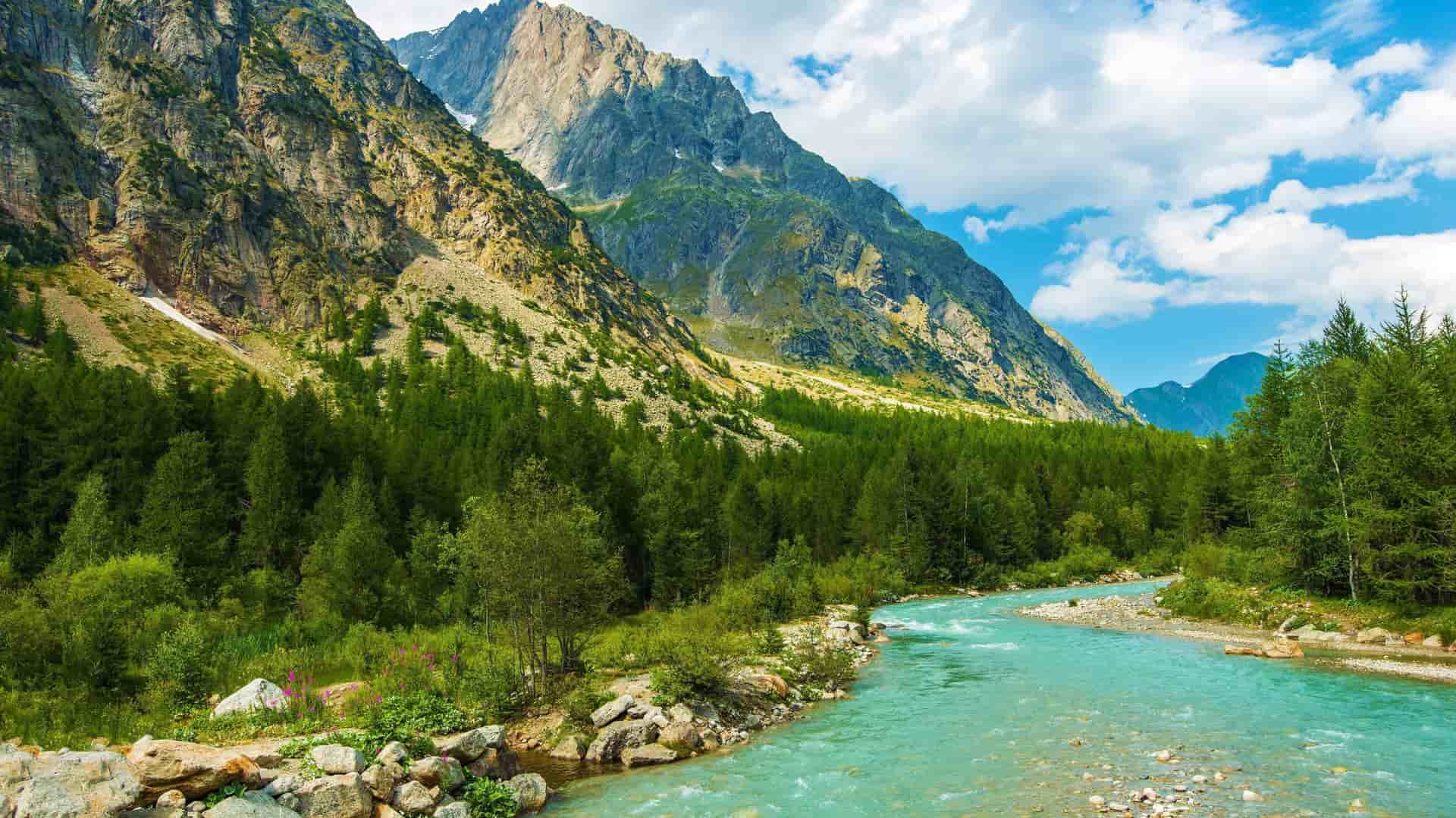 A turquoise stream through Alps in Northern Italy, an exciting destination for a Cosmos tour.