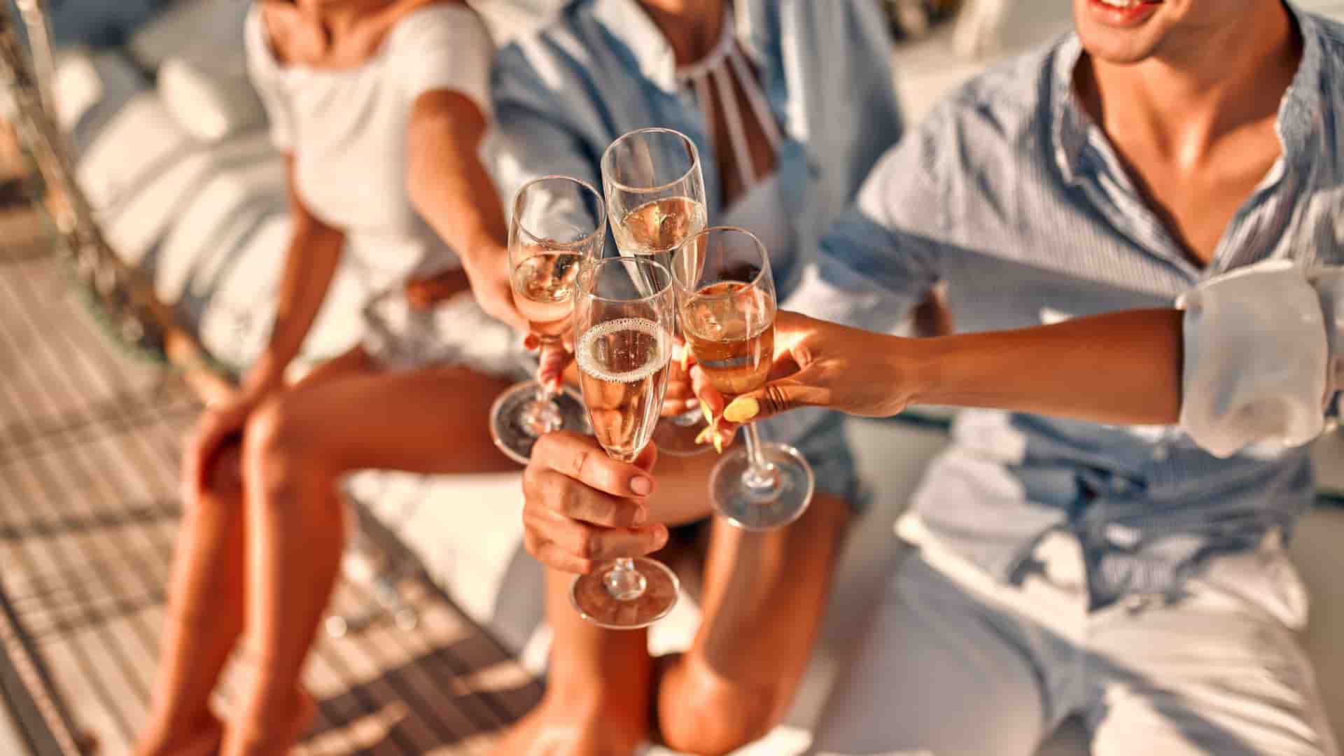 Four friends drinking champagne on a luxury cruise.
