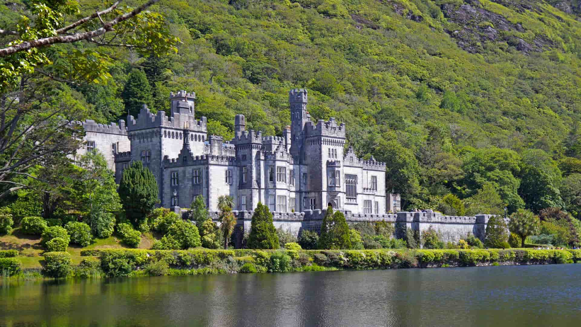 Kylemore Abbey surrounded by lush green foliage in Galway, Ireland.