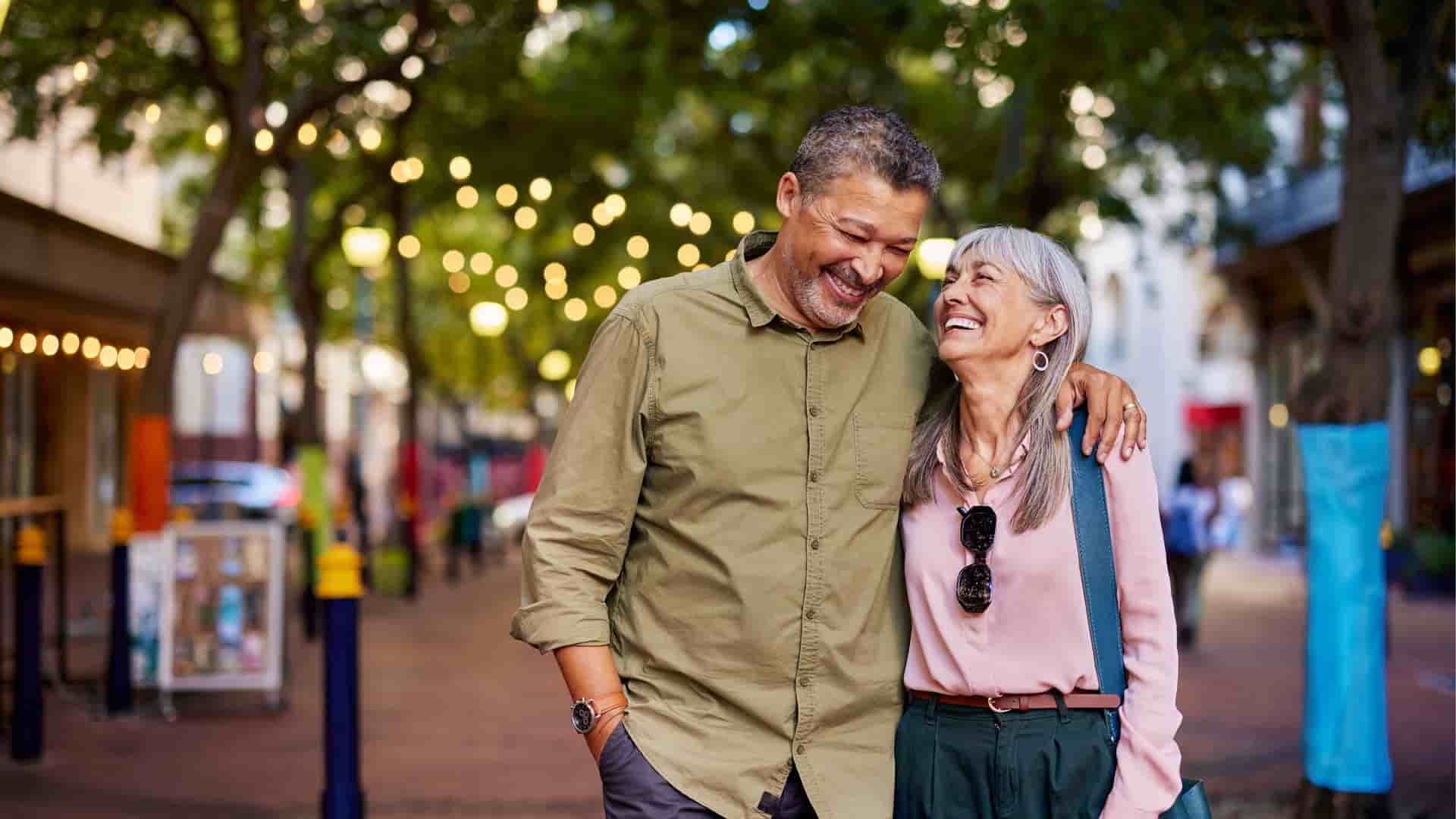 A couple walking and talking together at evening time.