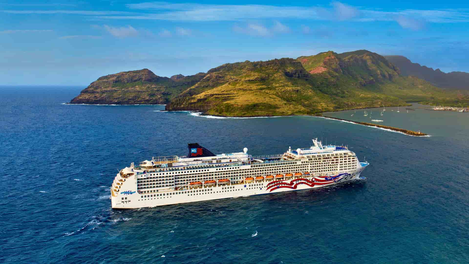 The Norwegian Cruise Line ship Pride of America sailing past the scenic coastline of the Hawaiian Islands, offering an island-hopping cruise vacation within the United States.