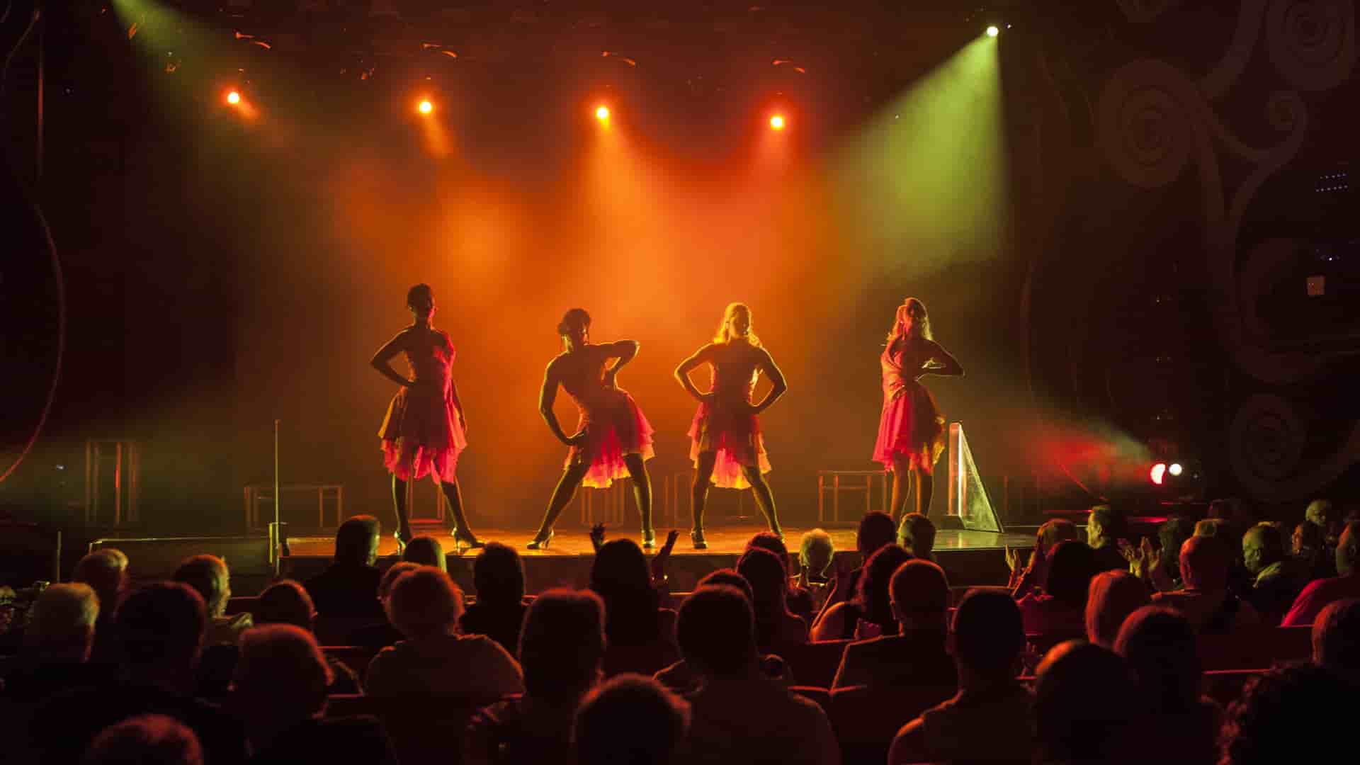 4 actors performing a musical during a Carnival cruise.