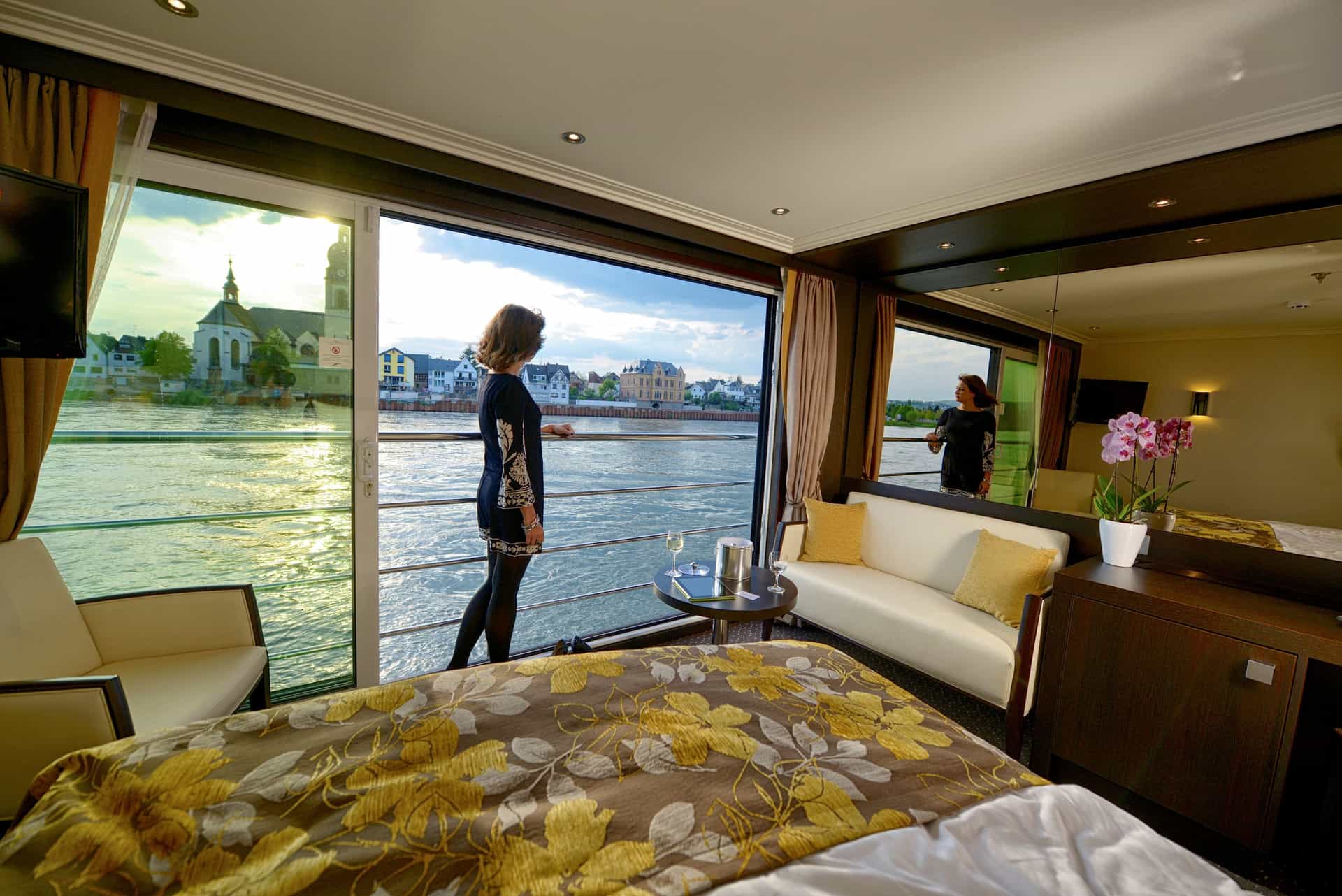 A woman looking out of the panoramic window view off the French balcony of the Avalon Expression,
