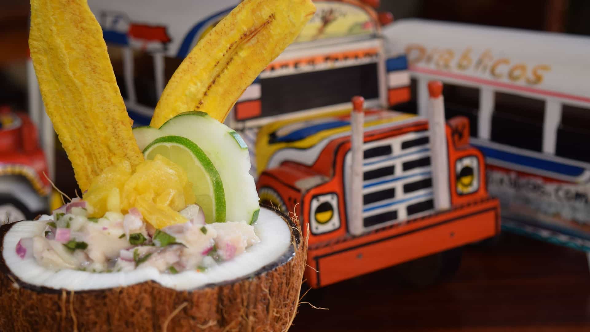 A close-up of a serving of Panamanian ceviche, typically made with white fish or shrimp cured in lime juice, mixed with finely chopped ingredients like red onion, red bell pepper, and cilantro (or culantro), and served in a glass or bowl, often with a colorful garnish.