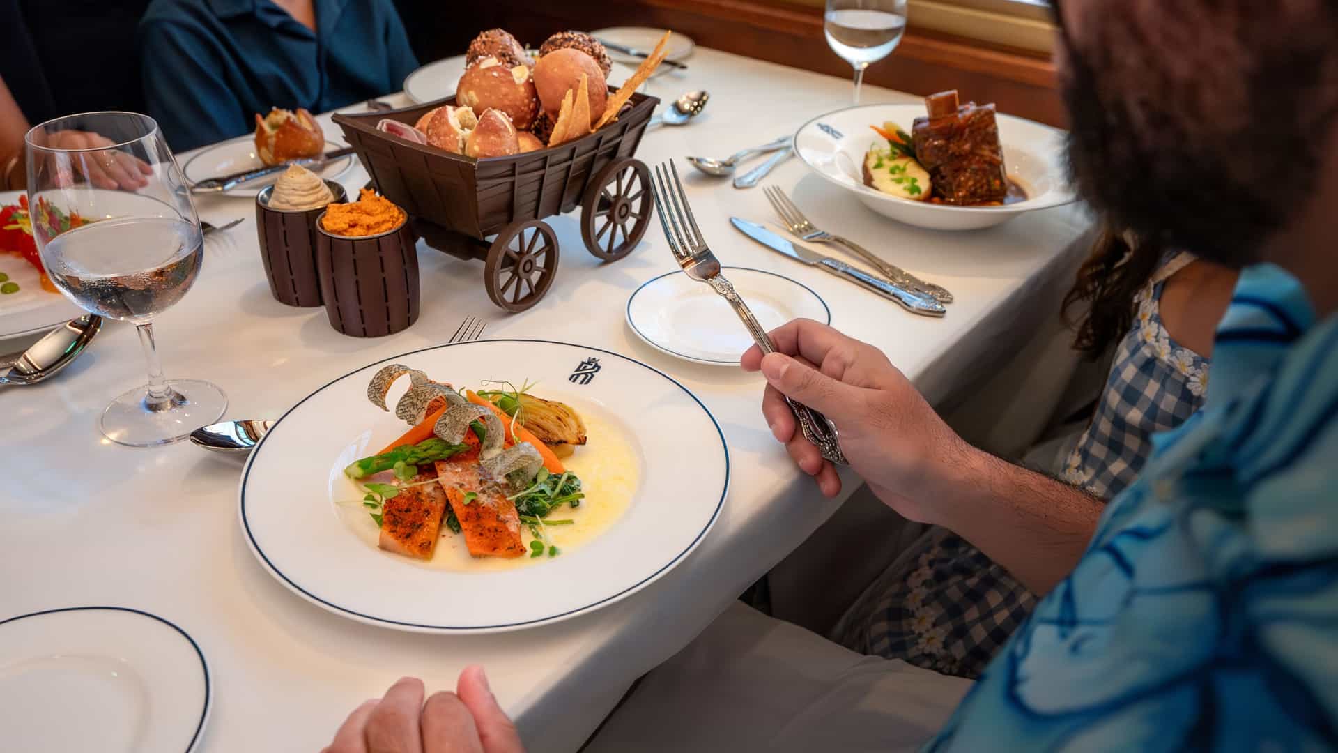 Family dining together at Utopia Railway on Utopia of the Seas. 