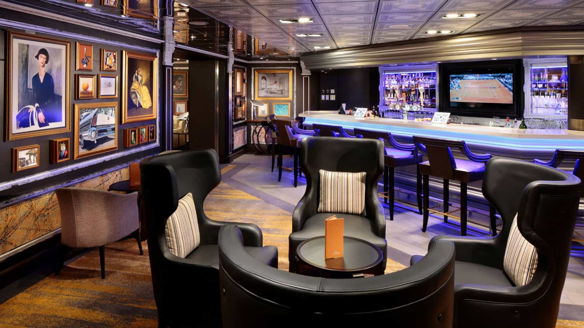 Guests relax in the sophisticated Gallery Bar aboard a Holland America Line cruise ship, surrounded by framed artwork and plush leather seating.