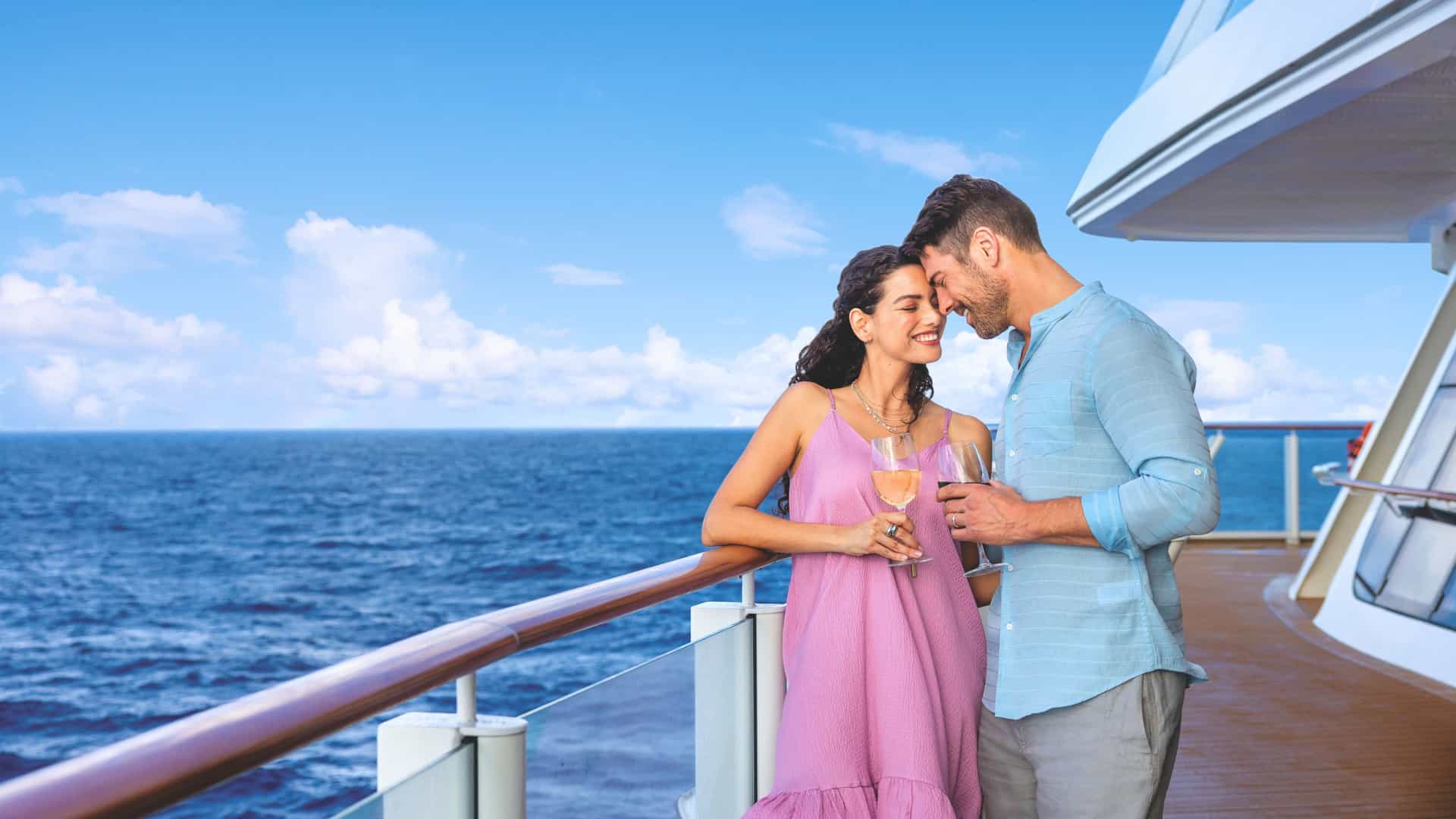 A couple enjoying a romantic ocean view from the aft deck of the Norwegian Encore cruise ship during a Transatlantic voyage in international waters. Ideal for serene and luxurious Norwegian Cruise Line getaways.
