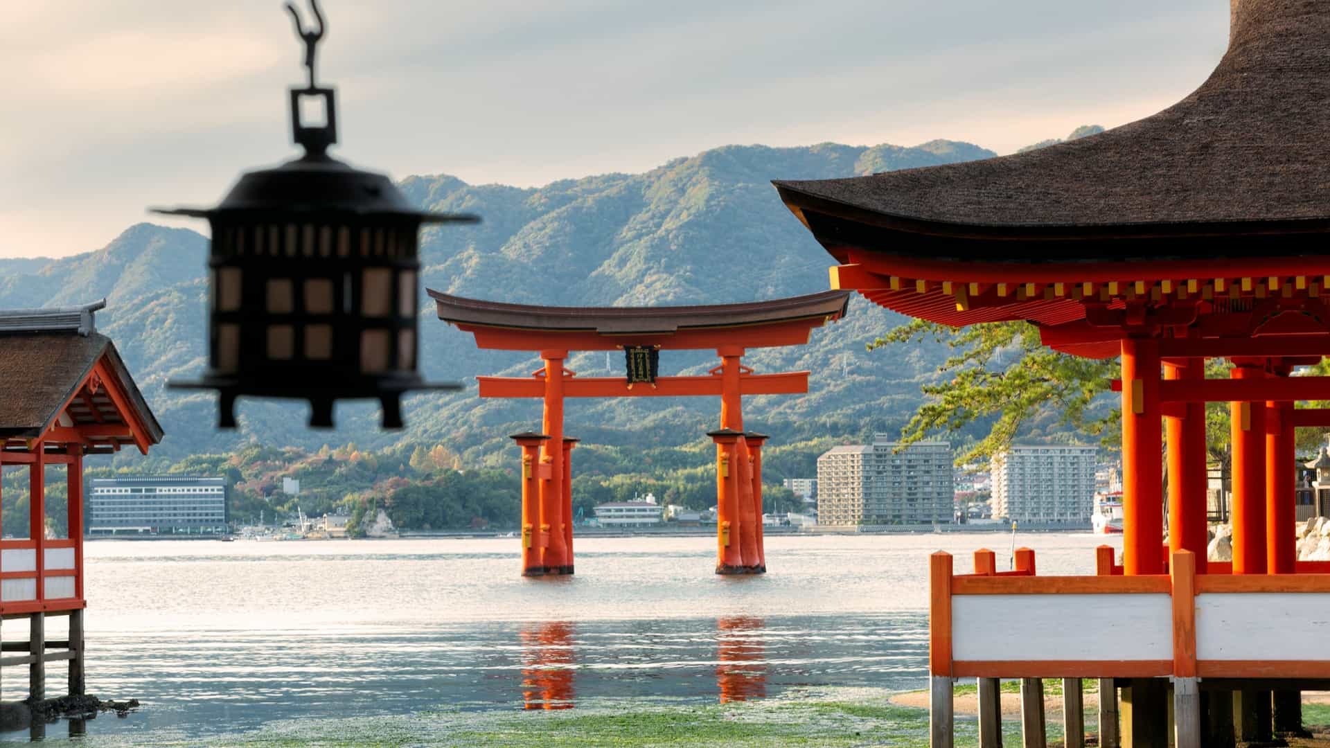 The iconic, orange-red floating torii gate of Itsukushima Shrine in the water off Miyajima Island, Japan.