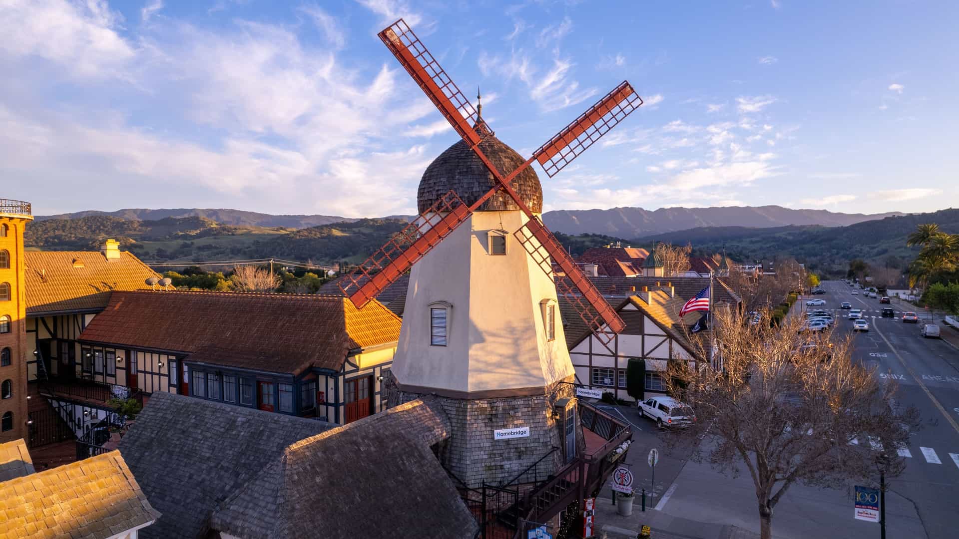 "An aerial view of a traditional Danish windmill in the charming town of Solvang, California, with its unique Scandinavian-style architecture, nestled in the Santa Ynez Valley.  "