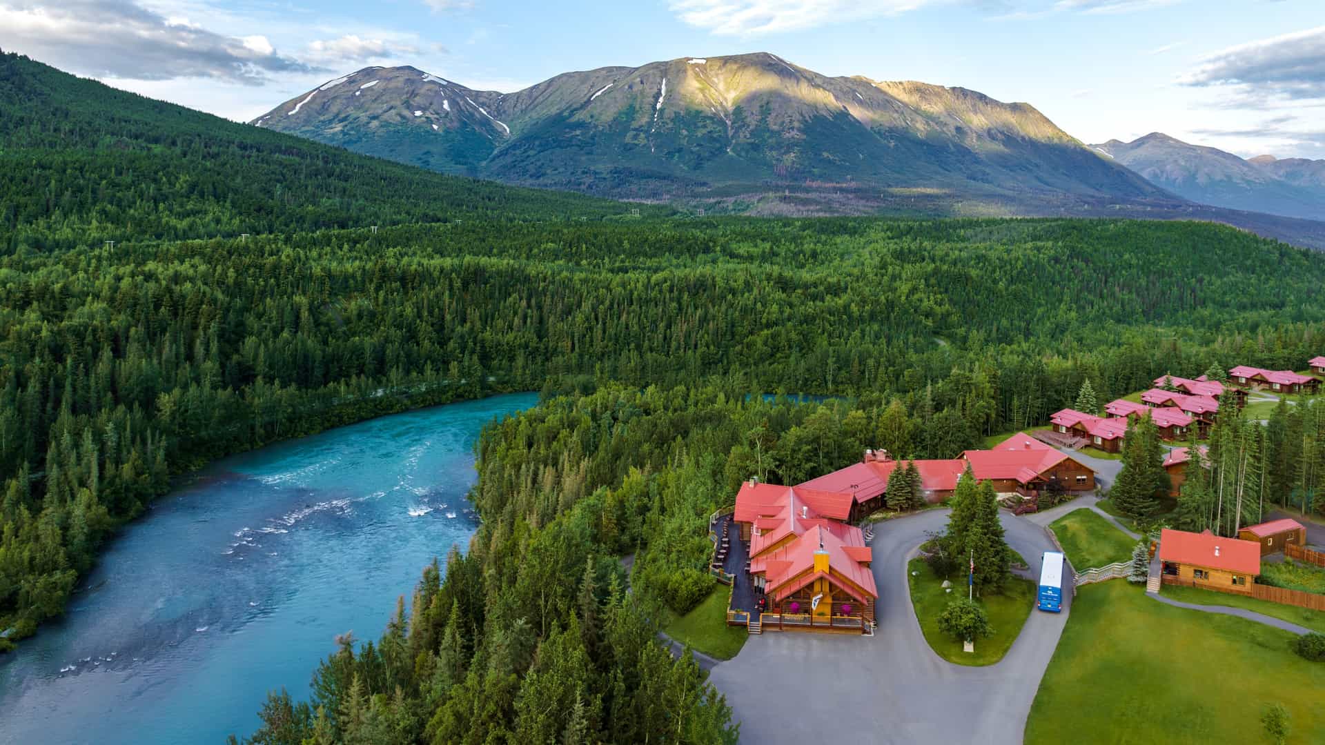 Aerial shot spanning across the Kenai Princess Wilderness Lodge in Alaska, showing the Kenai River,