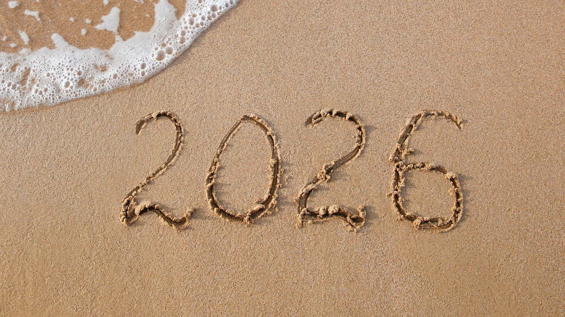 2026 written in the sand at a beach on a warm day.