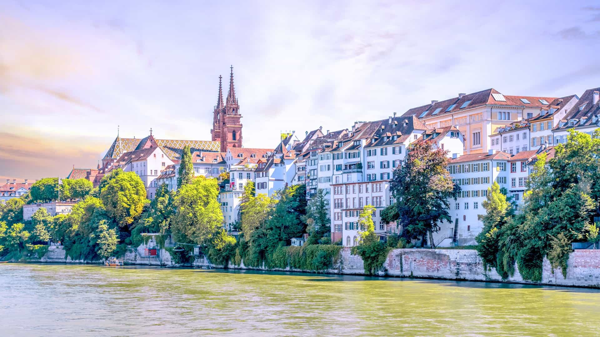 Sunset view of the old city of Basel, Switzerland, with historic architecture along the river—an enchanting stop on Viking River Cruises' Northern Europe itinerary.