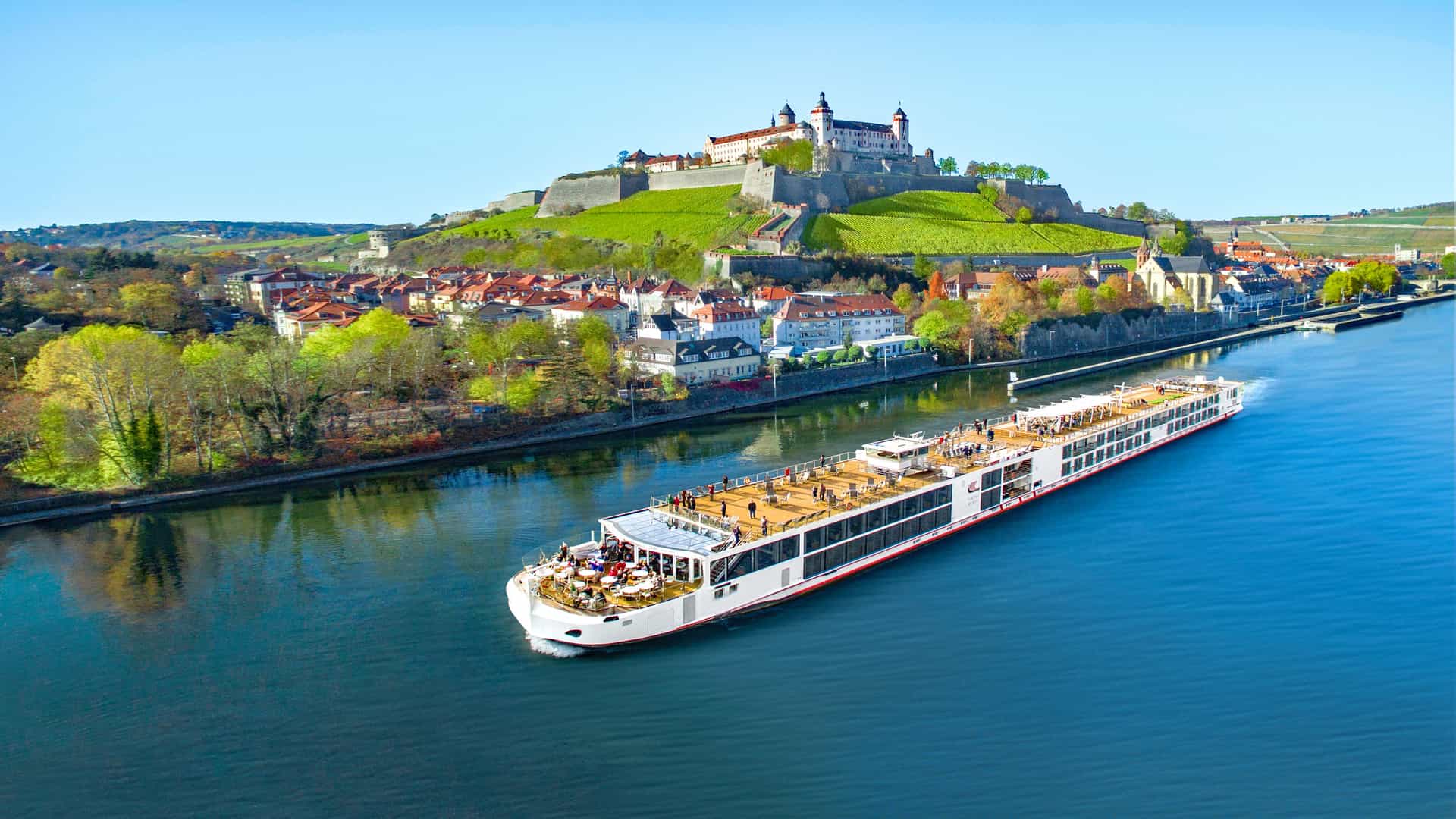 Viking Hild sailing a European River with a castle in the background.