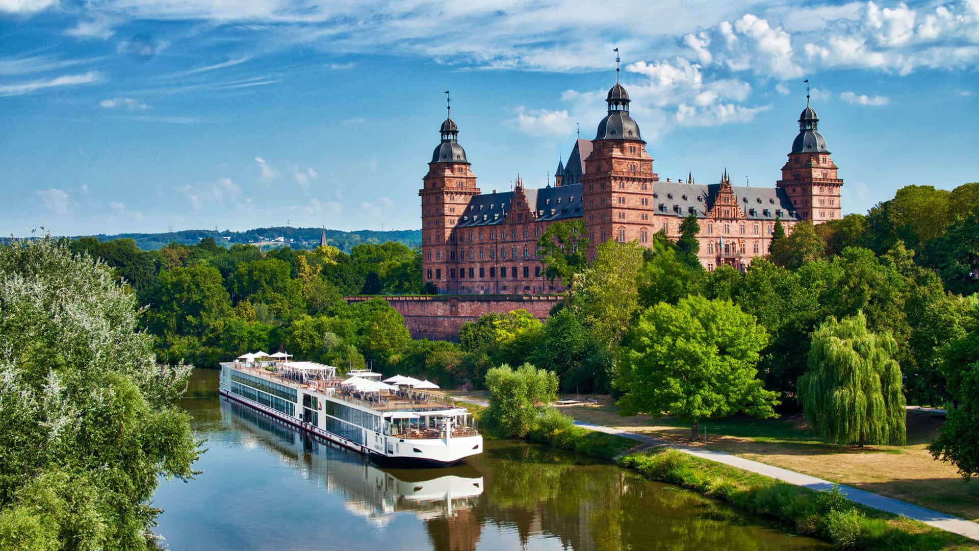 Viking River cruise ship sailing in front of the Johannisburg Palace in Aschaffenburg, Germany