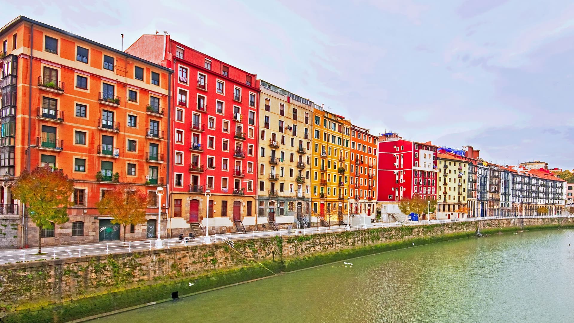 Colorful buildings along river in Bilbao.