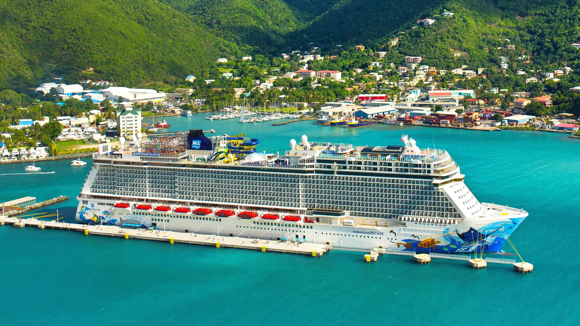 Norwegian Escape docked in a Caribbean port.
