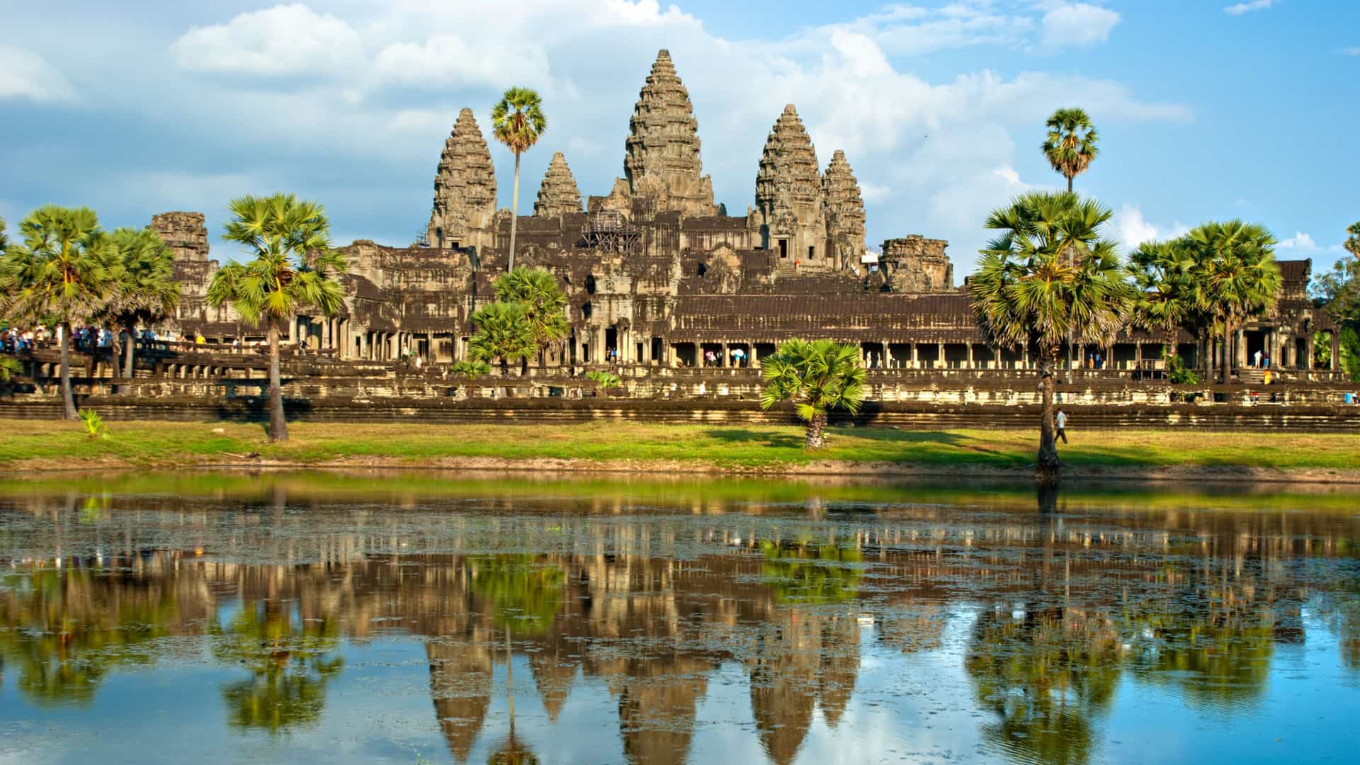 Angkor Wat temple in Cambodia with towers and carvings reflected in water on a Celebrity Cruises Southeast Asia itinerary.