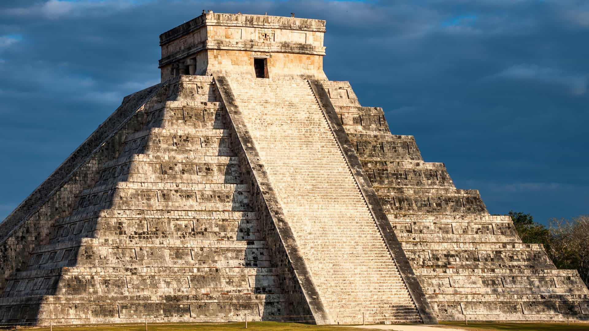 El Castillo pyramid at the Mayan ruins of Chichen Itza under a dramatic sky on a Celebrity Cruises excursion in Mexico.