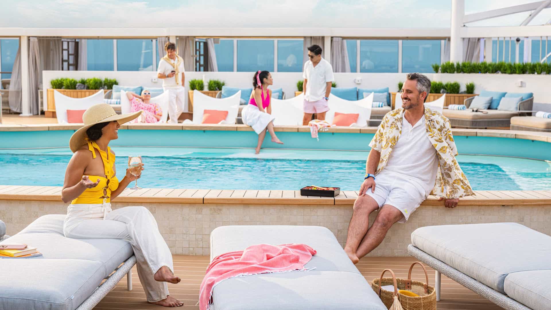 Couple sitting poolside in the adults only Sancturary on a Princess cruise.