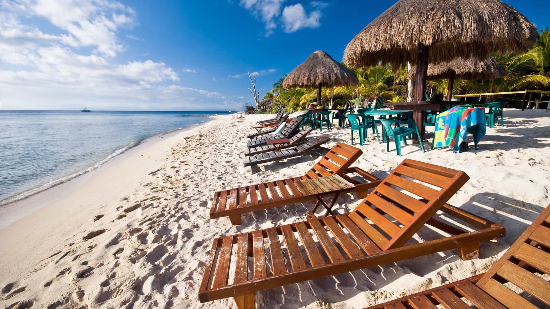 Tropical beach with lounge chairs in Cozumel.