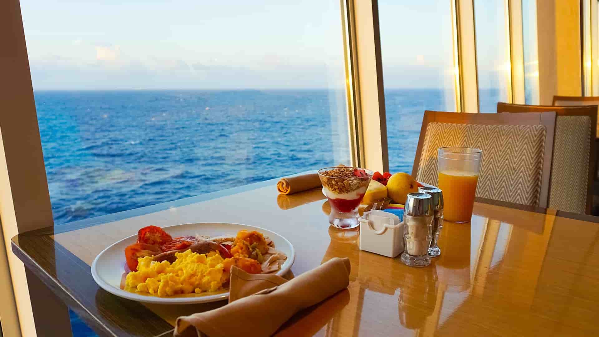 Elegant breakfast table aboard a cruise ship with ocean views