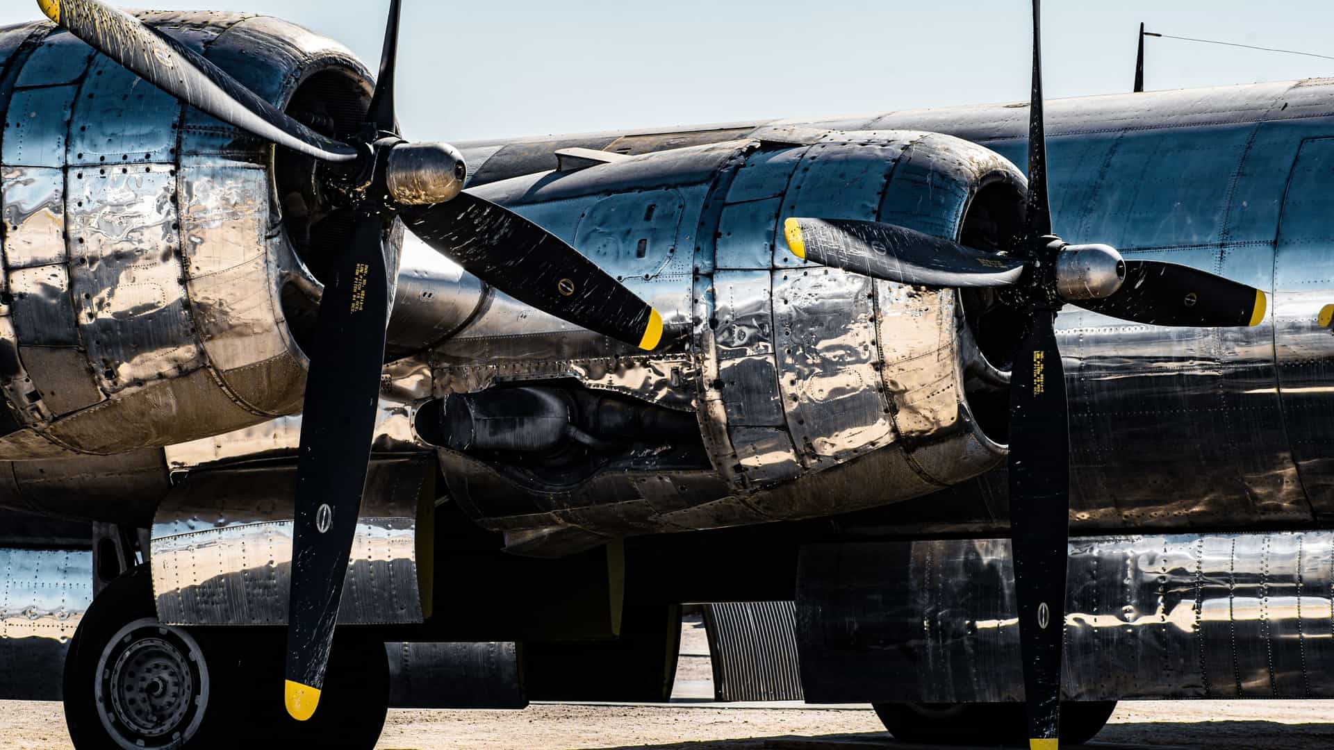A vintage military aircraft is displayed inside the Darwin Aviation Museum in Darwin, Northern Territory, Australia. The image captures the historic plane's metallic fuselage and wings under the museum's large roof.
