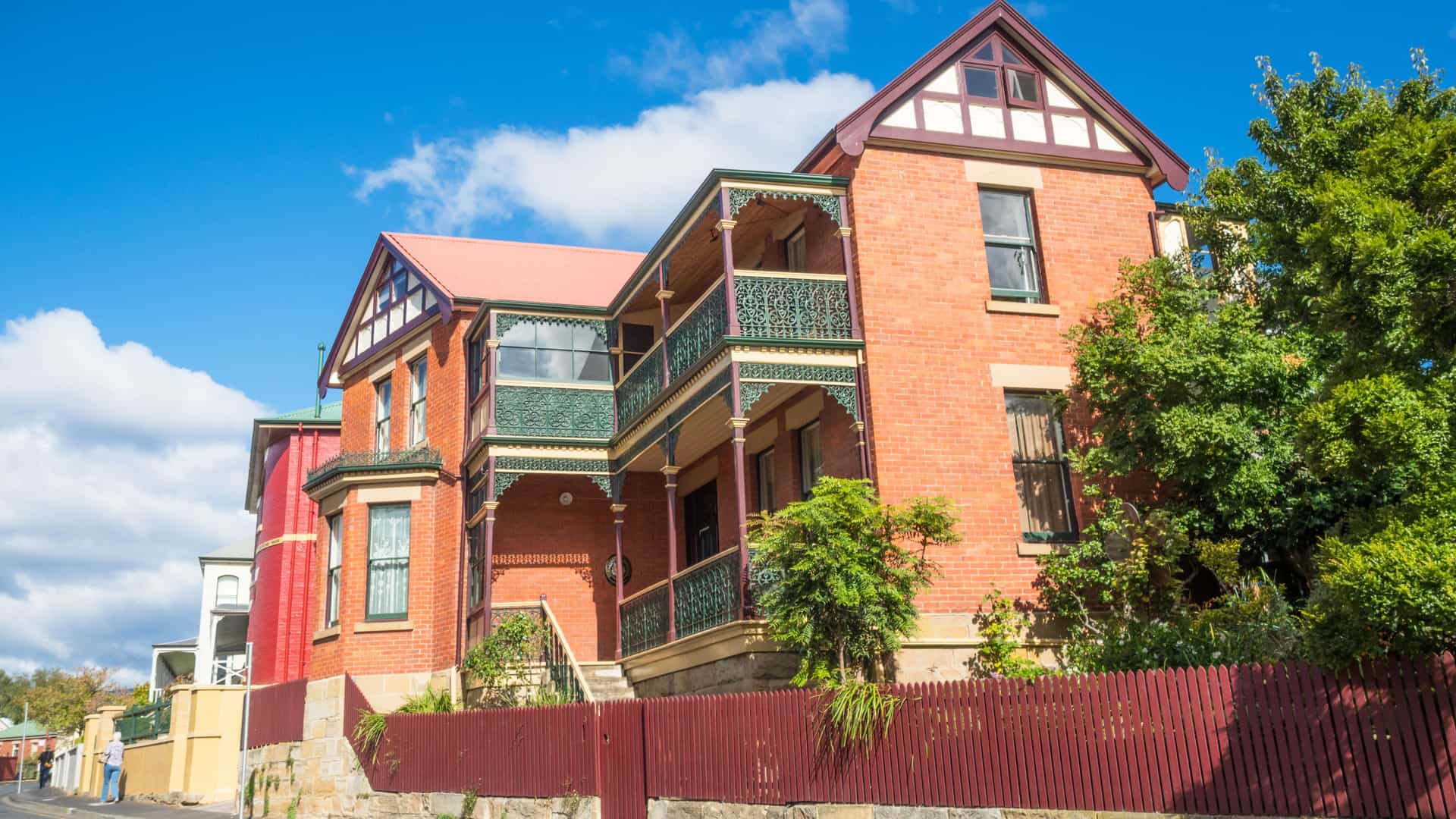 A street-level view capturing the heritage colonial architecture of Battery Point in Hobart, Tasmania, Australia. The image features the area's characteristic winding streets, well-preserved cottages, and may include notable landmarks like the Arthur Circus cottages or the historical buildings along Hampden Road.