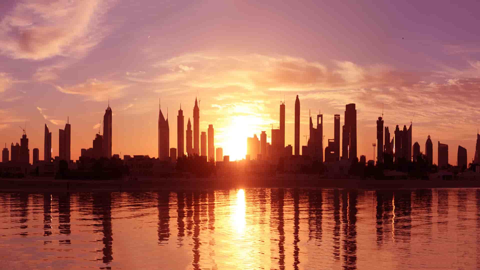 Burj Al Arab and Dubai skyline at sunset.