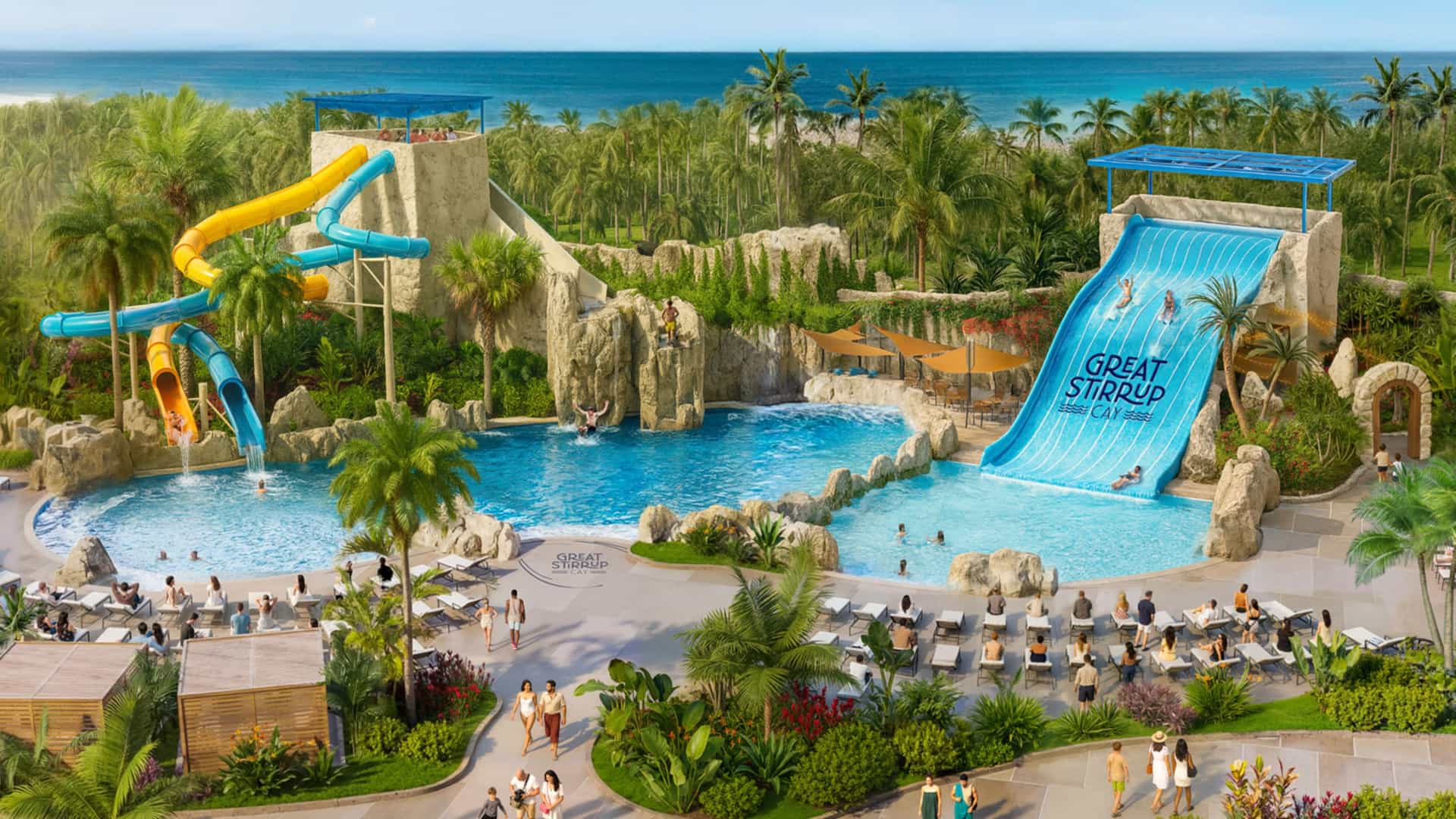 An outdoor waterpark area at Norwegian Cruise Line's Great Stirrup Cay, featuring twisted yellow and blue body slides on the left and a wide blue ramp slide labeled Great Stirrup Cay on the right, all emptying into swimming pools surrounded by artificial rock formations, lounge chairs, and tropical palm trees.