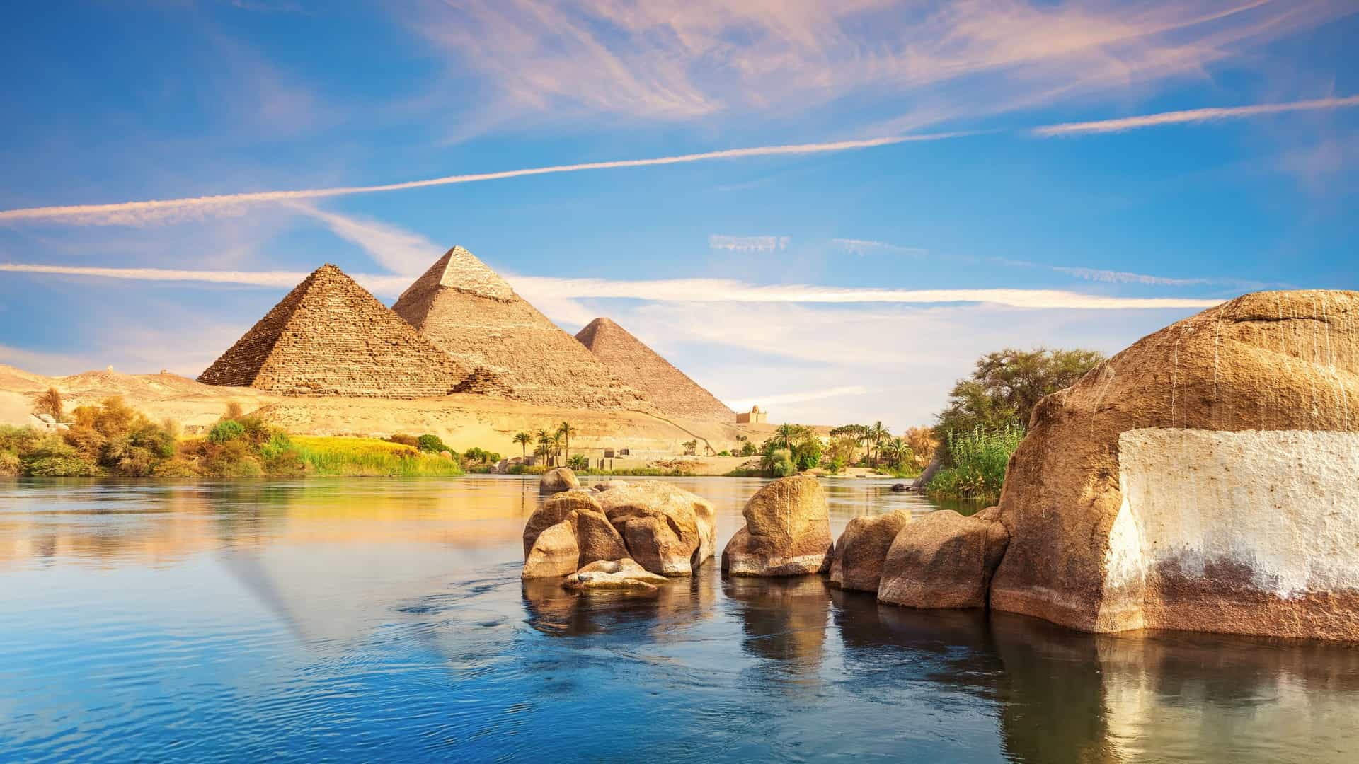 The Great Pyramids of Giza stand majestically against the Egyptian landscape, showcasing ancient architectural marvels.