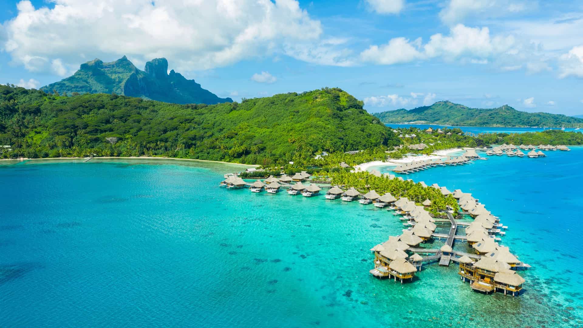 Oceania Cruises Bora Bora: Overwater bungalows in turquoise lagoon, a Transpacific dream.