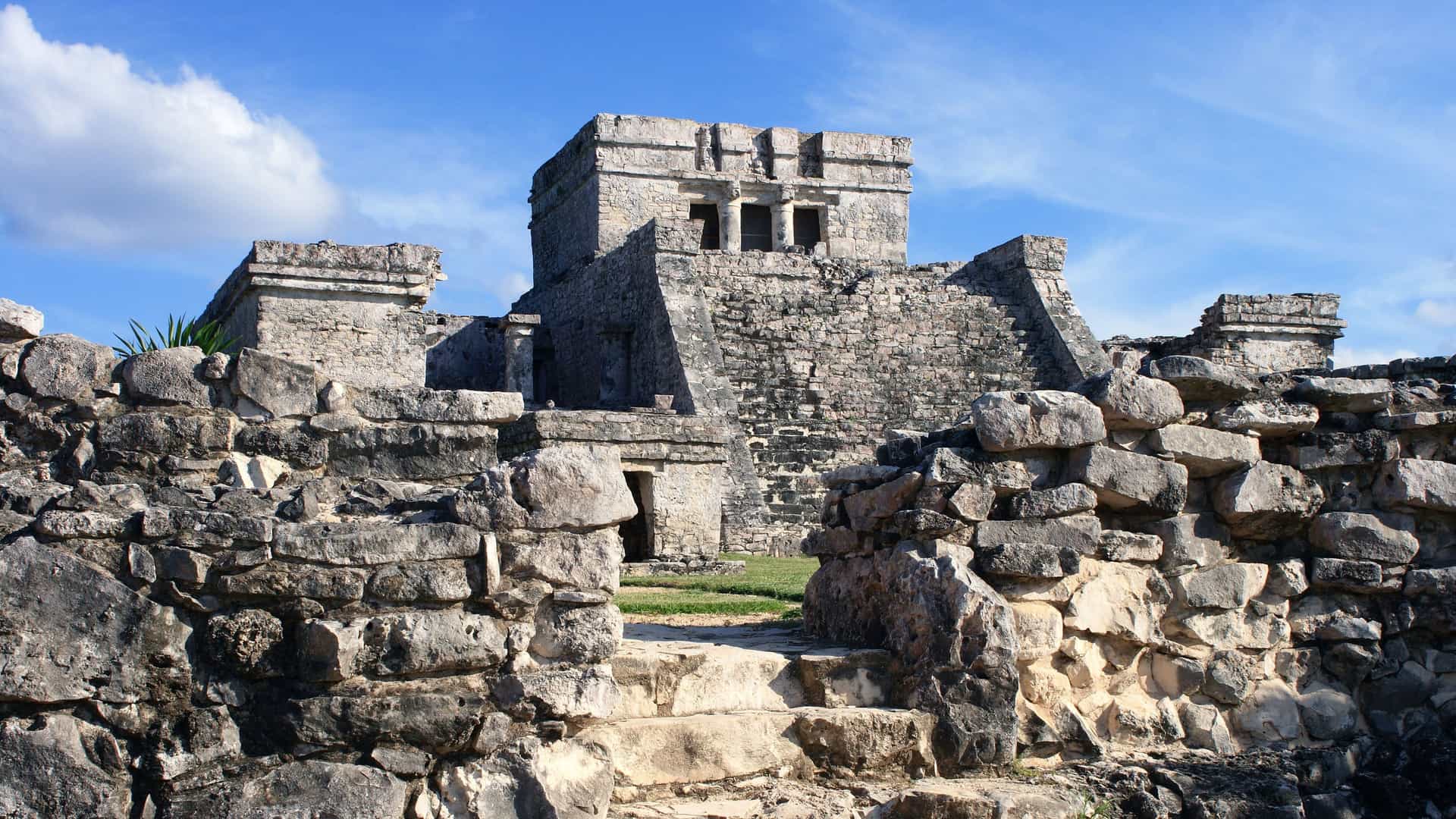 The ancient stone ruins of a majestic Mayan temple or pyramid, featuring historic architecture at an archaeological site in Mexico's Costa Maya region.