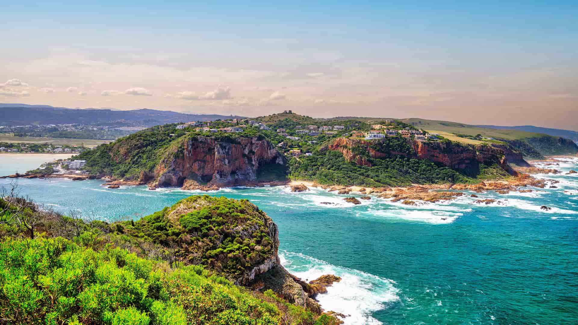 "A scenic view of the Knysna Heads, two dramatic sandstone cliffs marking the entrance to the Knysna Lagoon from the Indian Ocean on the Garden Route of South Africa. "