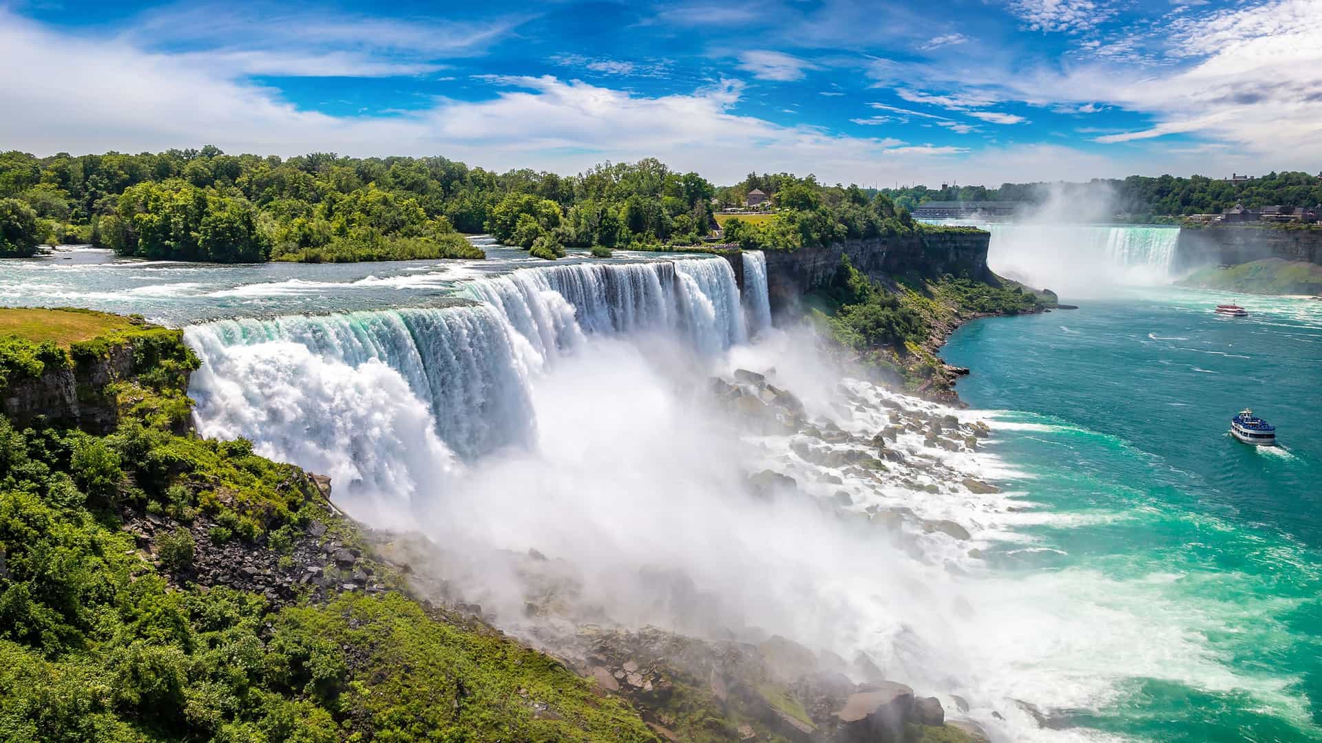 "A panoramic view of the majestic Niagara Falls from the New York side, showing the powerful American Falls cascading into the Niagara River. "