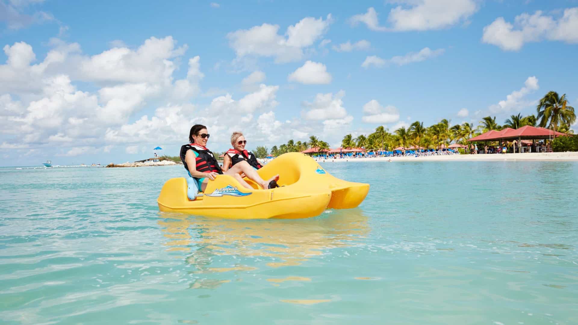 Guests enjoy a pedal boat in the shallow, clear turquoise waters of Princess Cays, a private island destination for water sports on Princess Cruises' Bahamas itineraries.