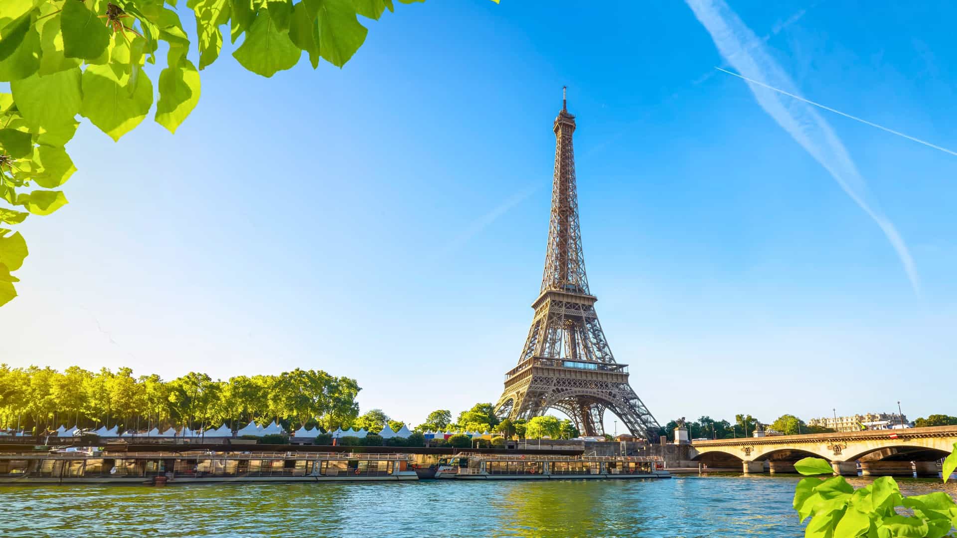 The iconic Eiffel Tower in Paris, France, viewed from the Seine River, representing a memorable overland adventure for guests on a Seabourn cruise.