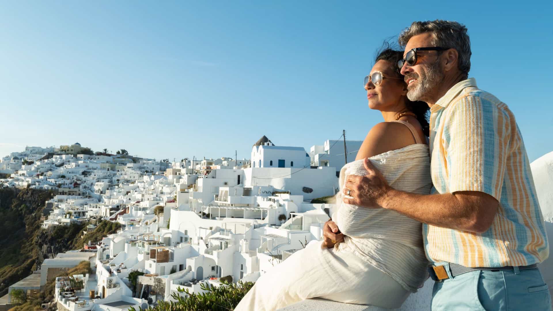 Couple enjoying a romantic moment in Santorini, Greece while on a Seabourn cruise.