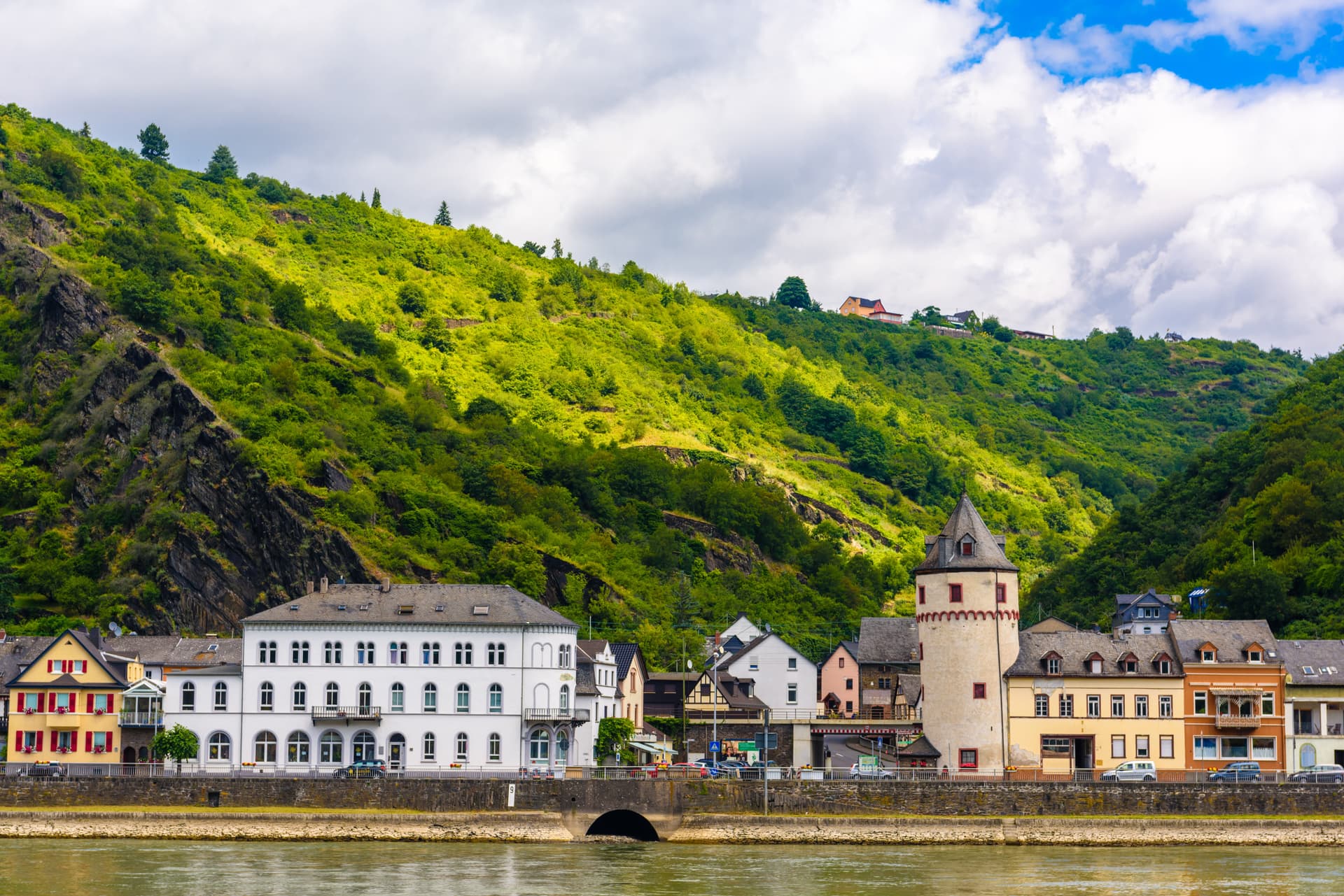 A beautiful waterfront view of the historic town of Sankt Goarshausen nestled along the Rhine River in Germany—a classic cultural shore excursion destination located near the famous Loreley rock.