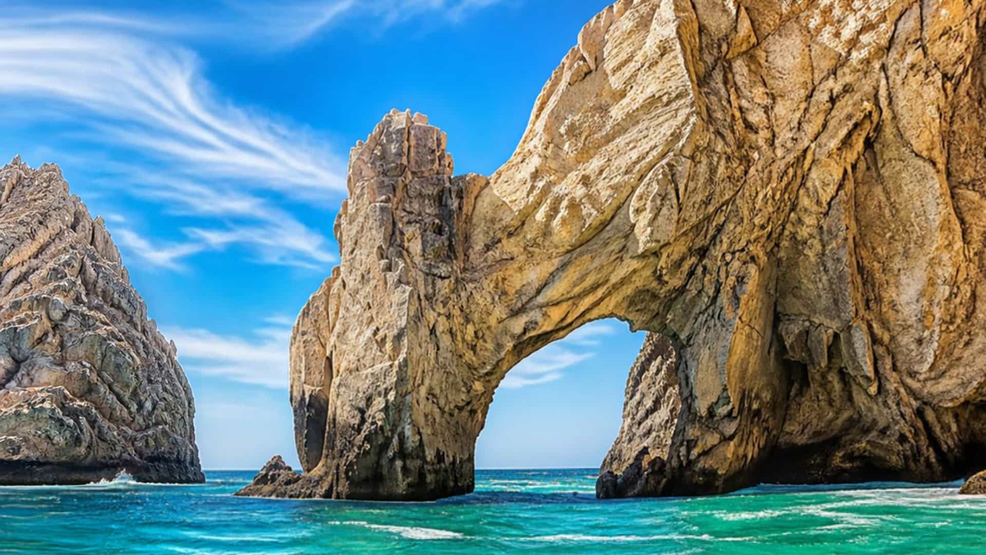 The Baja coastline near San Jose del Cabo, Mexico, with the iconic El Arco rock formation rising from turquoise water.
