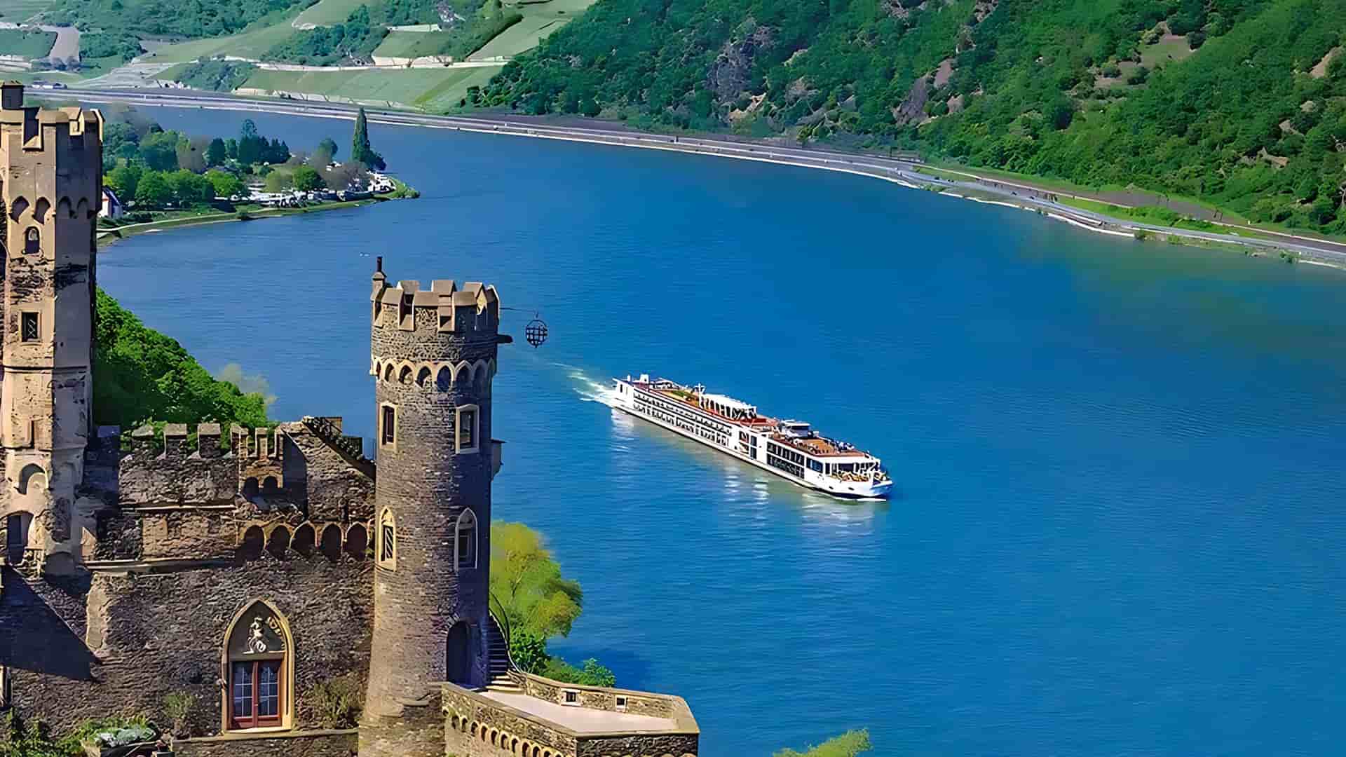 Viking Herja sailing a European river with a castle in the foreground.
