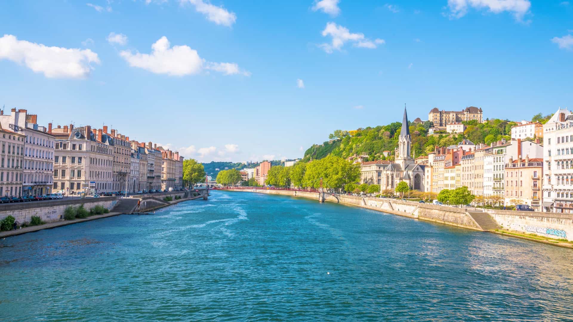 A scenic view of the city of Lyon, France, with its beautiful architecture along the banks of the Saône River, a historic stop on a Viking River cruise.
