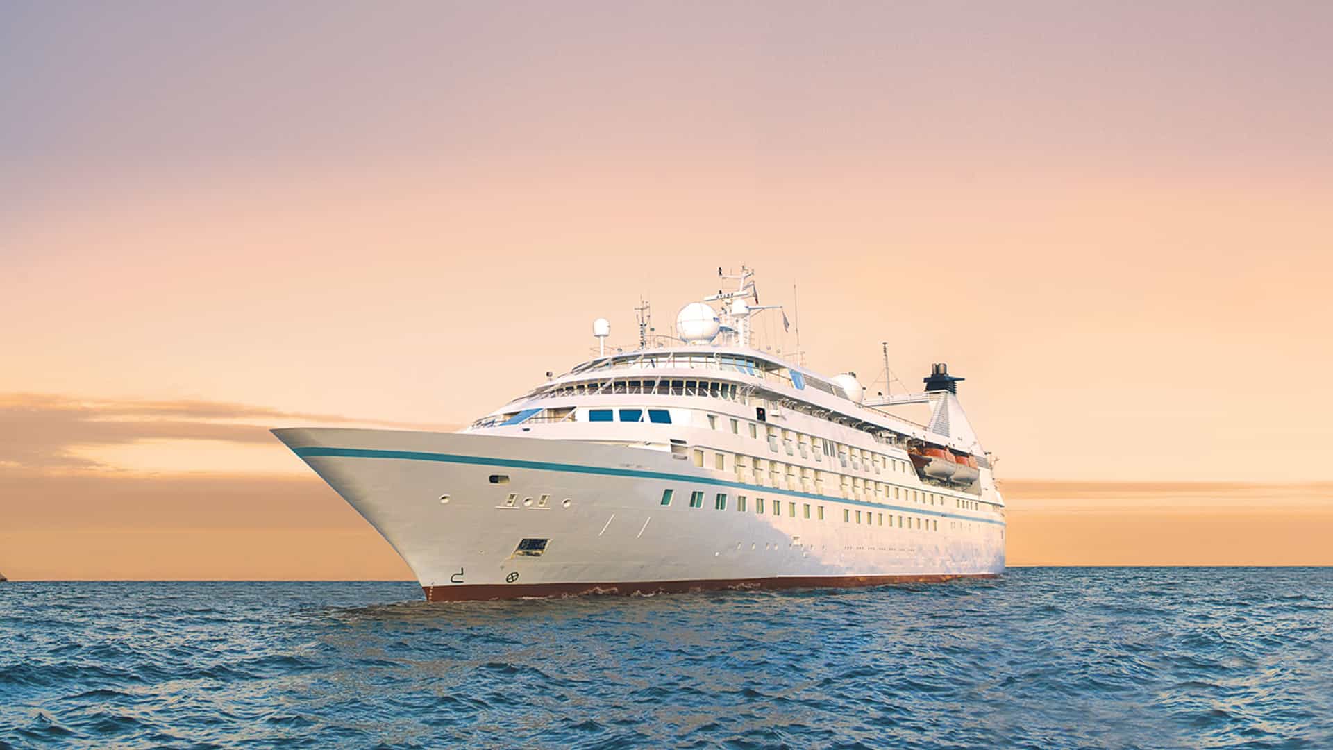 Windstar's Star Legend cruise ship sailing at sunset.