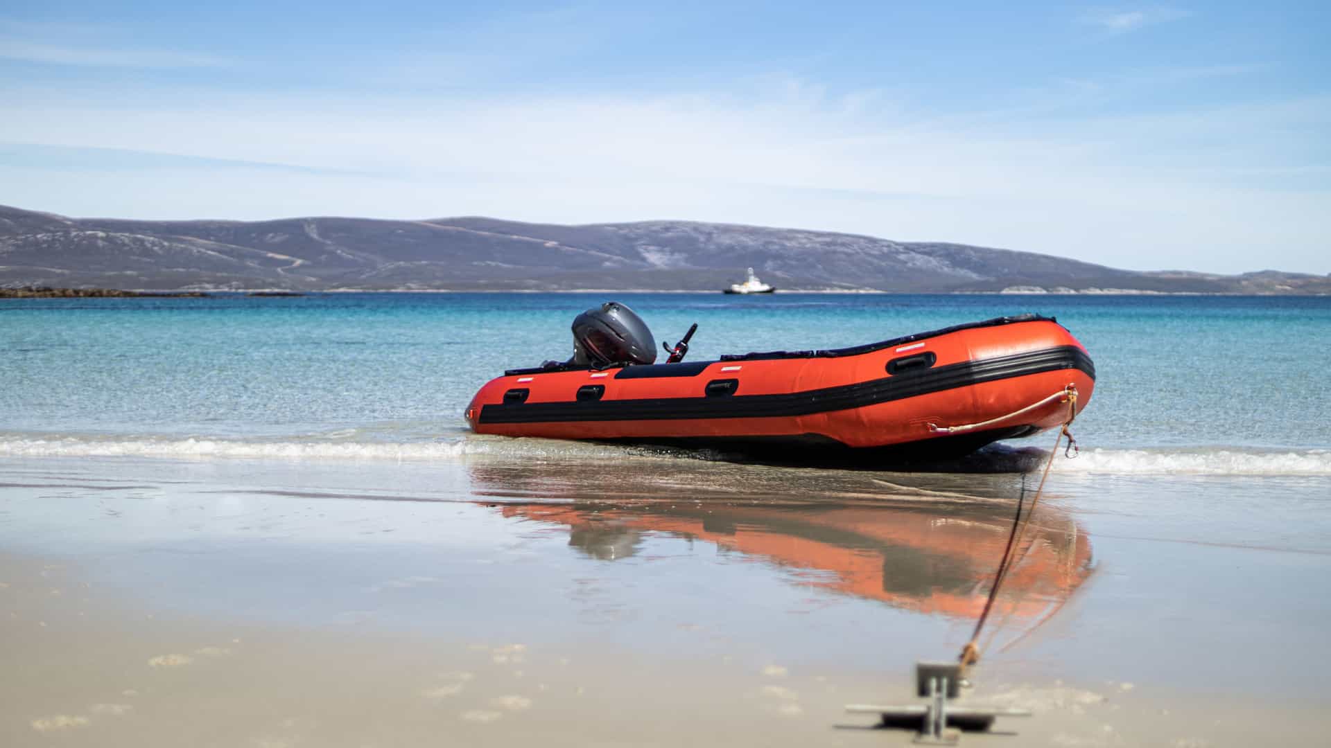 An inflatable Zodiac boat anchored on the beach for a cruise shroe excursion.